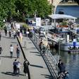 People walk on the banks of the Seine River in Paris on May 15 as France eases lockdown measures taken to curb the spread of the COVID-19 pandemic