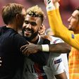 Paris Saint-Germain's Champions League quarter-final matchwinner, Eric Choupo-Moting, gets a hug from coach Thomas Tuchel