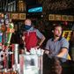 Patrons, some wearing masks and some not, sit at a bar in Austin, Texas, on June 26, 2020, as Governor Greg Abbott said he had allowed bars to reopen too soon