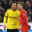 Bayern Munich striker Thomas Mueller (R) says he welcomes the challenge issued by Borussia Dortmund captain Mats Hummels (L) for next season.