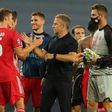 Bayern Munich head coach Hans-Dieter Flick (C) celebrates with Benjamin Pavard after their Champions League semi-final win over Lyon.