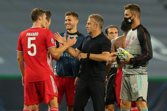 Bayern Munich head coach Hans-Dieter Flick (C) celebrates with Benjamin Pavard after their Champions League semi-final win over Lyon.