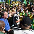 Brazilian President Jair Bolsonaro (C) has opposed lockdown measures