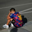 A boy wearing a Lionel Messi shirt waits for the Argentinian to arrive for coronavirus tests at Barcelona's training ground on Sunday.