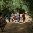 Sudanese women walk in the capital Khartoum's district of Jureif Ghar