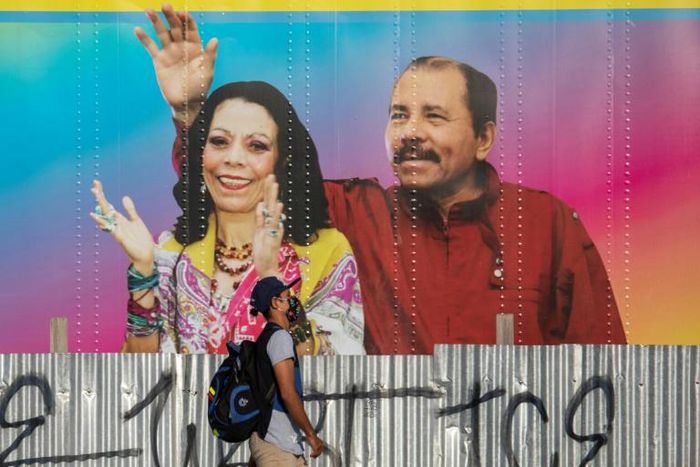 A man in Managua walks in April 2020 by a mobile health clinic displaying a picture of Nicaragua's President Daniel Ortega and his wife, Vice President Rosario Murillo, whose son Juan Carlos Trujillo has been hit by US sanctions