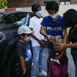 Maria, a domestic worker from Mexico, and her children receive food donations at a distribution center in Corona, Queens