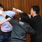 Lu Ming-che of the KMT （left) fights with DPP lawmaker Wu Ping-jui (centre)