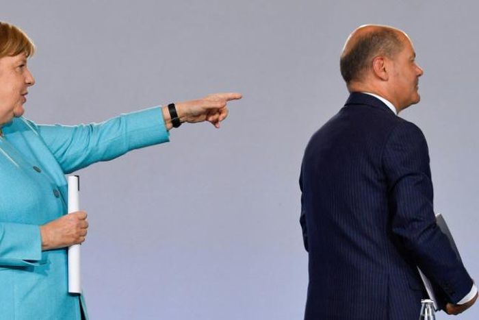 German Chancellor Angela Merkel points to Finance Minister Olaf Scholz after announcing the new stimulus package