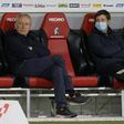 Waiting game: Freiburg coach Christian Streich (left) sits on the bench prior to Friday's game