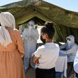 People queue to get tested for coronavirus at the field hospital in El Hamma. The town's hospital has no intensive care beds, and the army set up the field hospital in mid-August to bolster the local response and screen suspected cases