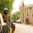 A UN peacekeeper patrols outside the mosque in Mopti, central Mali: two members of the peacekeeping mission have died of coronavirus, the organisation said