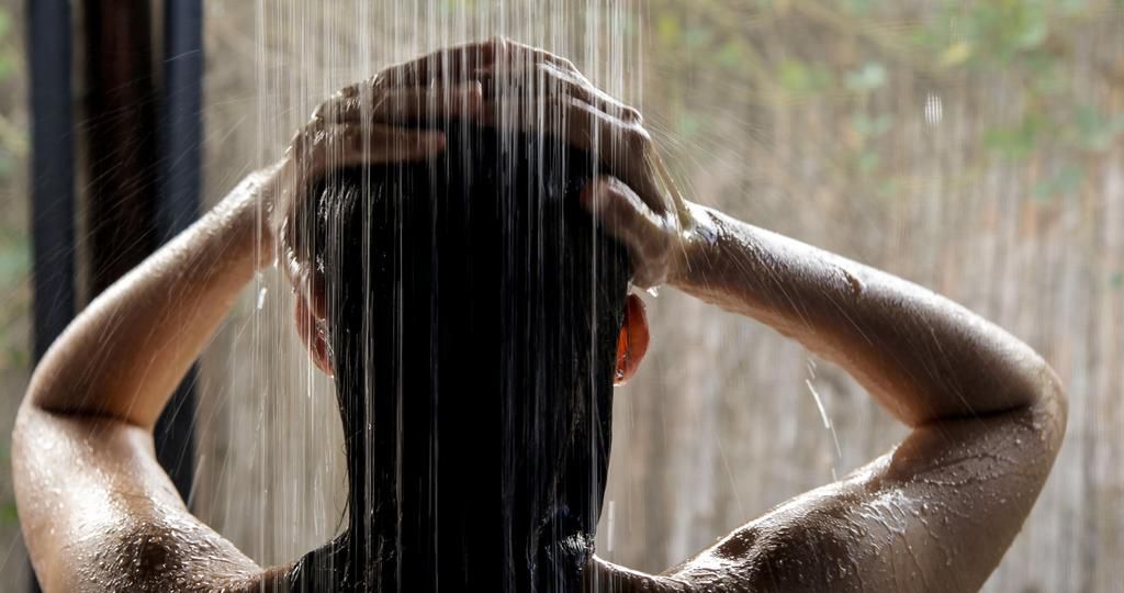 Headshot, hispanic woman taking a shower