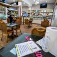 Hand sanitizer available for clients and tables set apart are part of the rules for reopening in Milan