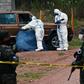 Honduran investigators pictured at the scene of a murder in Tegucigalpa in May 2020