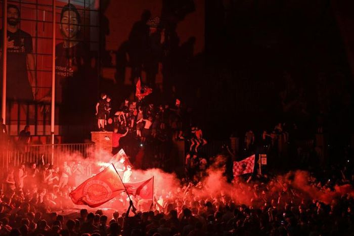 Fans celebrate Liverpool winning the Premier League title outside Anfield