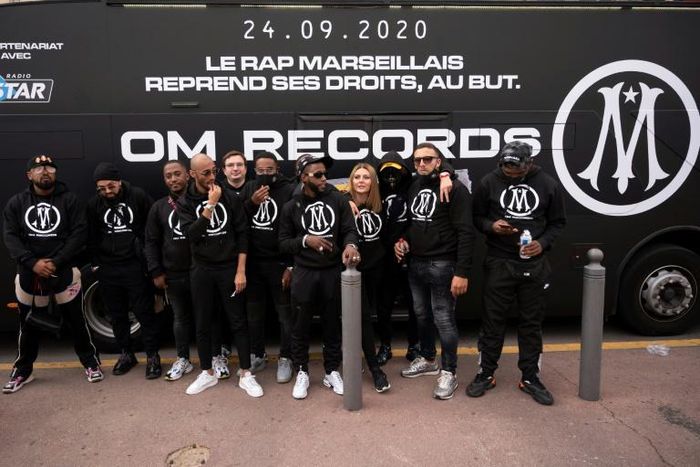 Rap artists from Marseille pose in front of a bus during the launch new rap record label OM Records