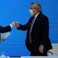 Argentina's President Alberto Fernandez (R) and Economy Minister Martin Guzman greet each other with a fist bump after announcing the restructuring of a $66 billion foreign-law debt