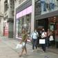 People walk the busy streets of Oxford Street in central London as it becomes compulsory to wear masks in shops