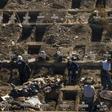 Workers dig graves in Santiago's General Cemetery after health authorities ordered them to prepare for a possible surge in deaths from COVID-19