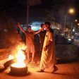 Libyan youth block a road with burning tyres in the eastern city of Benghazi to protest against poor public services and living conditions