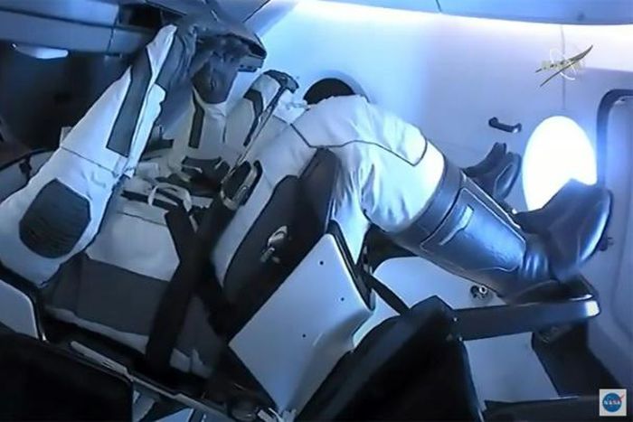 Astronauts Bob Behnken and Doug Hurley seen carrying out final preparations in the SpaceX "Endeavour" which should land off the coast of Pensacola at 2:48 pm (1848 GMT)