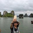 Local tourists take selfies in Ha Long Bay