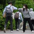 A staff member greeted students with an elbow bump as they returned to Kyungbock High School in Seoul after being closed for more than two-months because of coronavirus