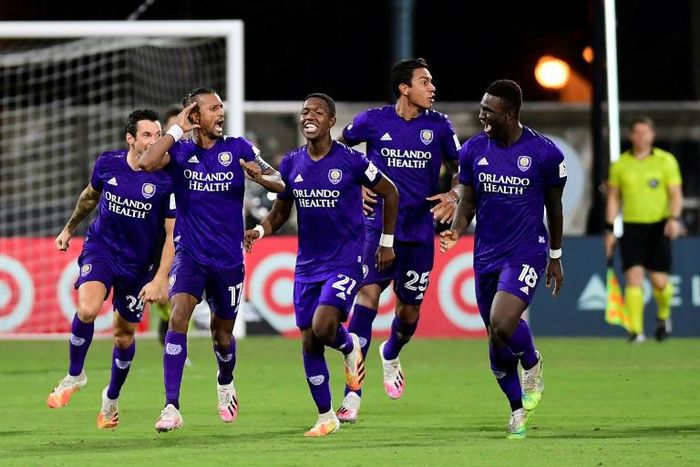 Orlando players celebrate after eliminating Los Angeles FC on penalties in the MLS restart competition