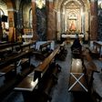 A man wearing a face mask sits on pews marked to help people keeping their social distance at Our Lady of Covadonga Parish in Madrid on May 13, 2020 during a national lockdown to prevent the spread of the COVID-19 diasease