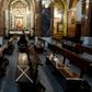 A man wearing a face mask sits on pews marked to help people keeping their social distance at Our Lady of Covadonga Parish in Madrid on May 13, 2020 during a national lockdown to prevent the spread of the COVID-19 diasease