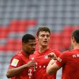Bayern Munich striker Robert Lewandowski (R) celebrates with defender Benjamin Pavard (C) and winger Serge Gnabry.