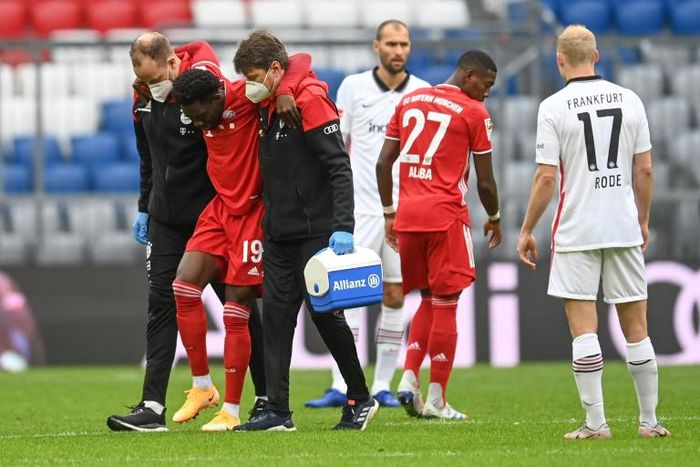 Alphonso Davies is helped off after tearing ankle ligaments on Saturday
