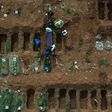 Aerial picture showing gravediggers burying an alleged COVID-19 victim at the Vila Formosa Cemetery, in the outskirts of Sao Paulo, Brazil