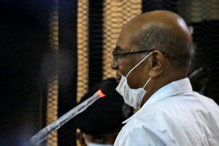 Sudan's ousted president Omar al-Bashir answers procedural questions during his trial in Khartoum