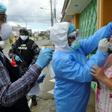 Health ministry personnel test a woman for the novel coronavirus in northern Guayaquil, Ecuador, on April 19, 2020