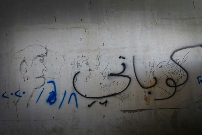 'Kobane' is written in Arabic script on a wall in Arbil, saluting the Kurdish-majority town in northern Syria that fought back Islamic State group jihadists in 2015