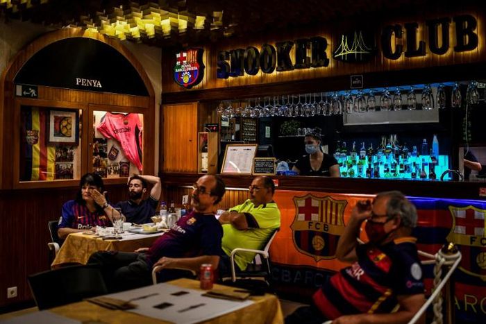 Barcelona fans look glum as they watch the game in a Lisbon bar