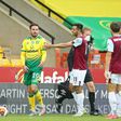 Referee Kevin Friend shows a red card to Norwich's Josip Drmic