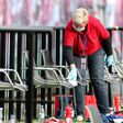 A member of staff cleans the substitute bench during half time of RB Leipzig's draw with Hertha Berlin