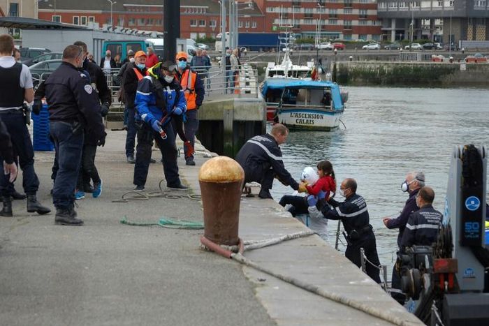 Britain's Conservative Party government has looked to increase pressure on France to prevent migrants coming into UK waters, such as these migrants being assisted by French gendarmes and police in Calais in May 2020 after a failed crossing attempt