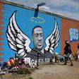 Visitors pay their respects to George Floyd in front of a mural in Houston, Texas on Monday, June 8, 2020