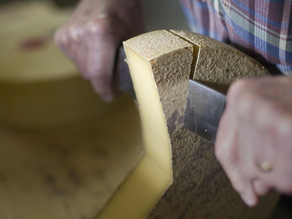 Cutting Swiss mountain cheese