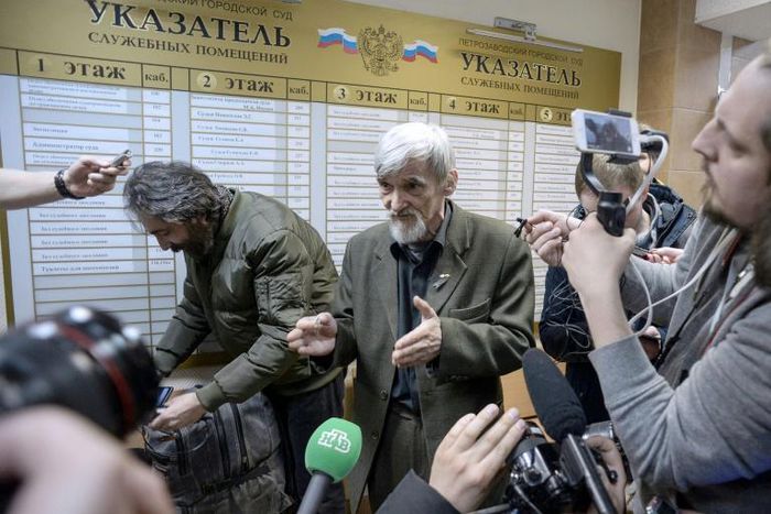 Russian historian Yury Dmitriyev (pictured April 2018), who heads rights group Memorial's branch in Karelia, speaks to the media as he leaves a court following the verdict in his child pornography trial in the northwestern city of Petrozavodsk