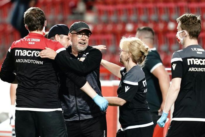 Union Berlin's Swiss head coach Urs Fischer (2ndL) celebrates with his team after victory over Paderborn on Tuesday confirmed they will stay up next season.