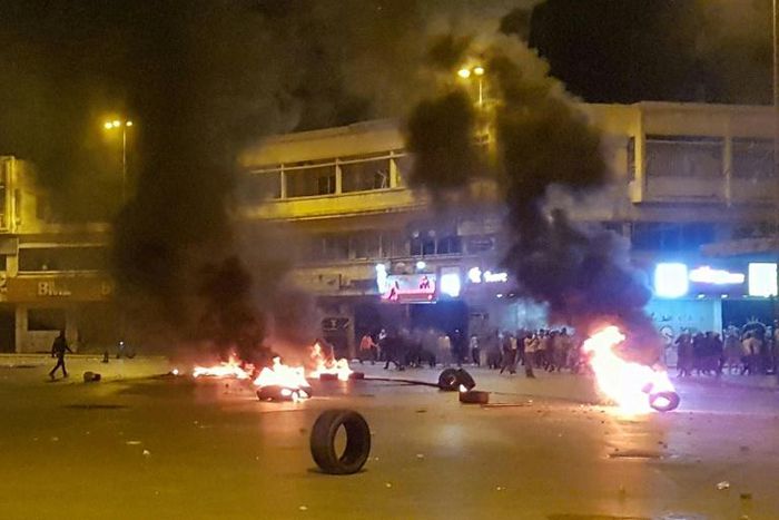 Lebanese anti-government protesters burn tyres amid overnight clashes with security forces in the northern city of Tripoli