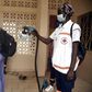Back to class: A Red Cross worker sprays a pupil with disinfectant at the entrance of a school in Dakar