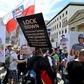 Protesters carried placards featuring German chancellor Angela Merkel as a prisoner