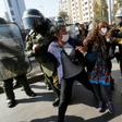 Riot police arrest demostrators in Santiago on Friday after breaking up a May Day protest that contravened social distancing rules