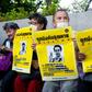 Protesters hold posters showing missing Thai activist Wanchalearm Satsaksit during a rally in Bangkok